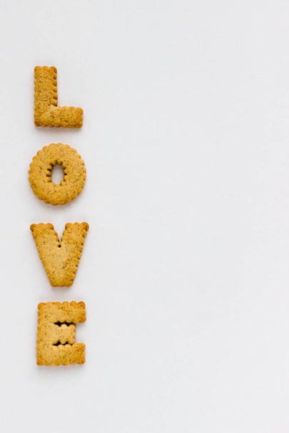 Love Lettering with Cookies on White Background. Top View Baked Letters Design Template. - Photo, Image