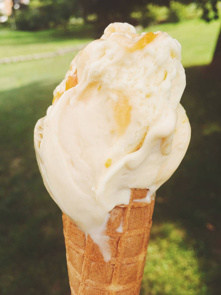 Ice cream cone melting outdoors in summer, sweet dessert food on - Photo, Image