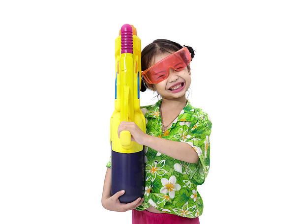 Young Asian girl with water gun on white background, Songkran Fe - Zdjęcie, obraz