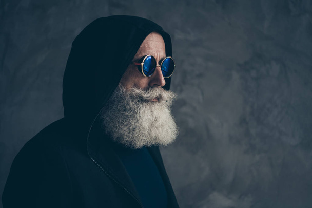 Close-up profile side portrait of his he nice attractive focused content bearded gray-haired man grandfather wearing hoody round specs life lifestyle isolated over concrete industrial wall background - Φωτογραφία, εικόνα