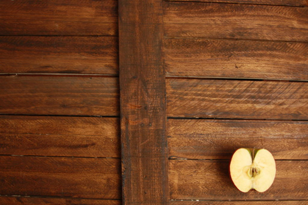 red apple cut in half on wooden background - Photo, Image