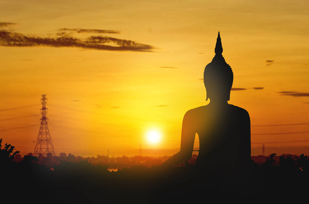 The large Silhouette Buddha on golden sunset background. Sky morning in Asia Thailand - Photo, Image