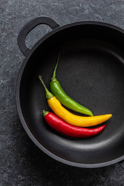 chillies mix in a black fry pan - Foto, afbeelding