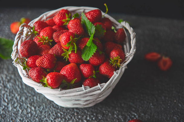 Ripe red strawberries on black background, Strawberries in white basket. Fresh strawberries. Beautiful strawberries. Diet food. Healthy, vegan. Copy space.  - Фото, изображение