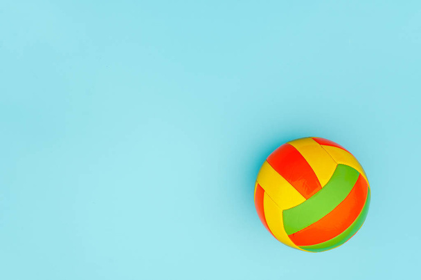 Bright multi-colored volleyball ball on blue background with copy space. Top view Flat lay Minimal style Template for card, design - Foto, immagini