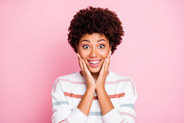 Photo of funny dark skin lady in best mood listen news about black friday shopping arms touch cheekbones wear white striped pullover isolated pink color background - Φωτογραφία, εικόνα