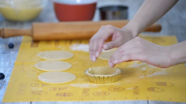 Pastry chef making tartlets, putting the dough in baking dishes. - Footage, Video