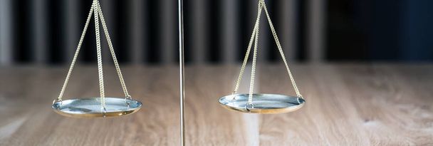 Law and Justice, scales on wooden table with blurred background. - Foto, afbeelding
