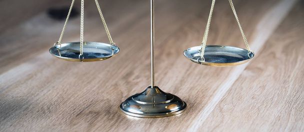 Law and Justice, scales on wooden table with blurred background. - Foto, Bild
