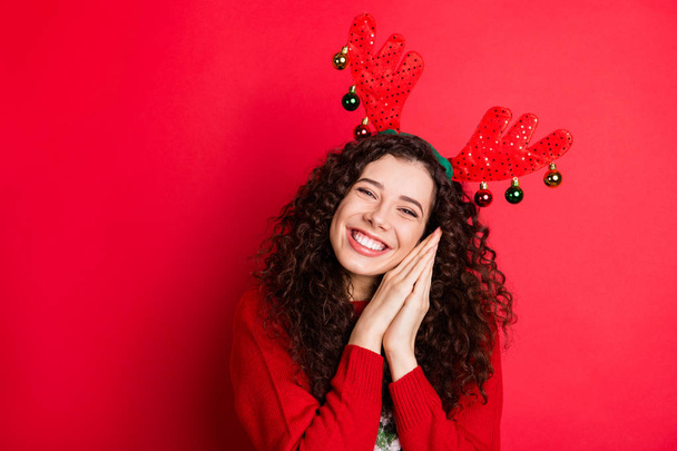 Portrait of cheerful funny funky brunette curly hair girl ready for christmas newyear party wait expect x-mas tradtion her gift present surprise wear trendy sweater isolated red color background - Valokuva, kuva