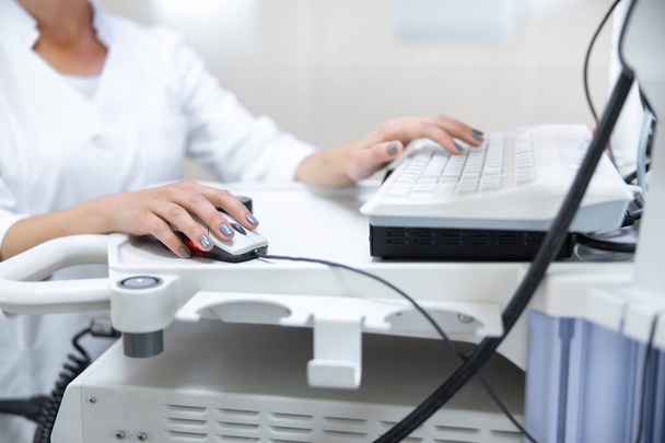 Woman using computer in clinic stock photo - Фото, изображение
