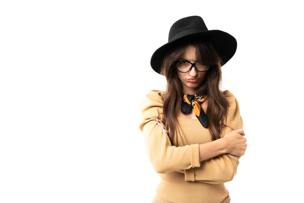 beautiful woman posing in studio against white in hat and eyeglasses  - Фото, зображення