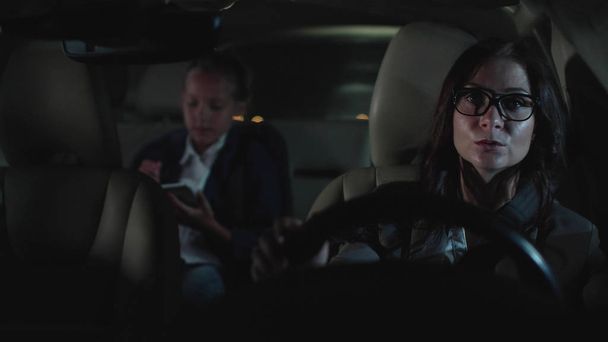 Woman and little girl drive in car at night. - Фото, зображення
