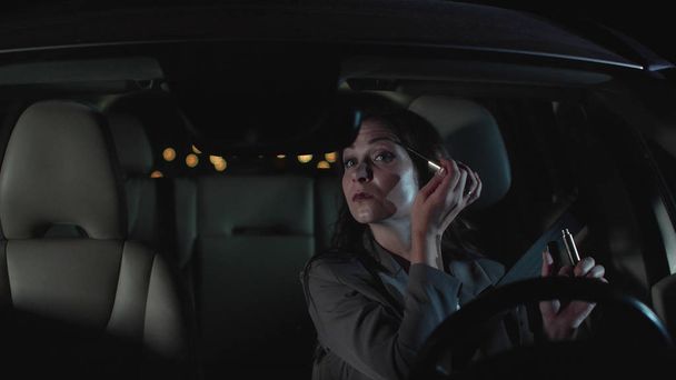 Pretty woman sit in car at night. - Foto, imagen