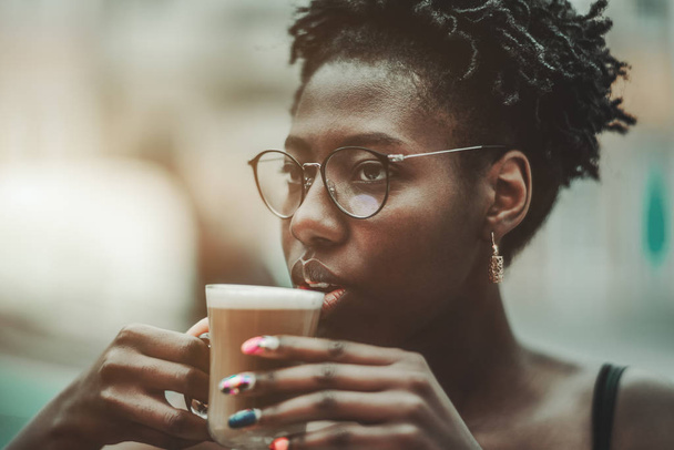 The black girl is drinking coffee - Photo, image