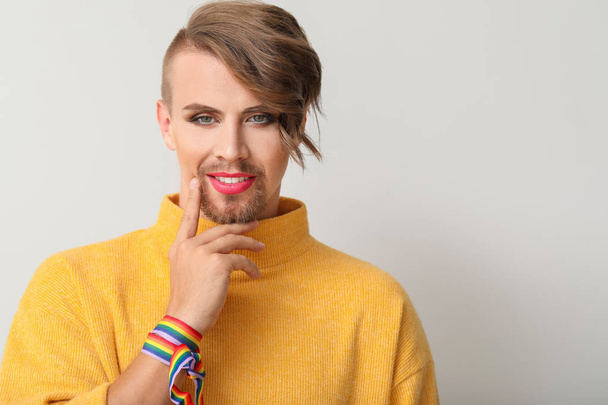 Portrait of young transgender woman on light background - Фото, зображення
