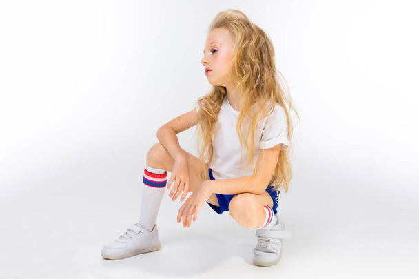 cute little blond girl posing in studio  - Photo, Image