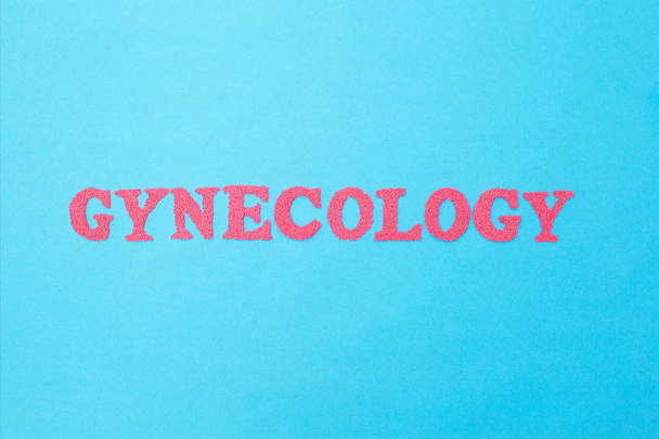 Gynecology inscription in red letters on a blue background. The  - Zdjęcie, obraz
