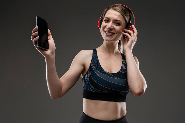 beautiful sportswoman listening to music  - Photo, image
