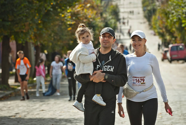 CHERNIVTSI, UKRAINE - SEPTEMBER 29. 2019 : Runners participating in the "Bukovina Mile" charity fun run. A short marathon race to support peace. Family-friendly sports and a healthy lifestyle. - Fotó, kép
