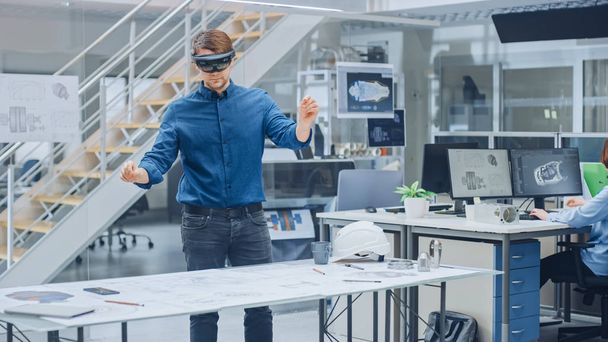 Engineering Software Developer Wearing Virtual Reality Headset Uses Gestures to Interact with Augmented Reality while Designing Industrial Engine Model in Modern Facility. AR Mock-up Concept - Photo, Image