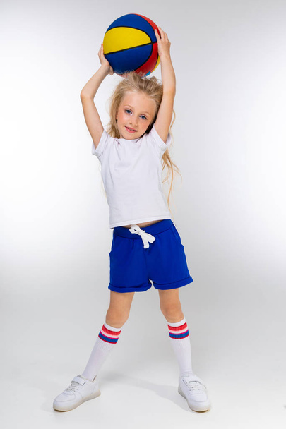 cute sporty little girl posing with basketball ball - 写真・画像