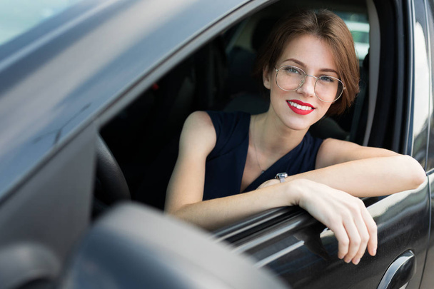 young beautiful woman posing in car  - Zdjęcie, obraz