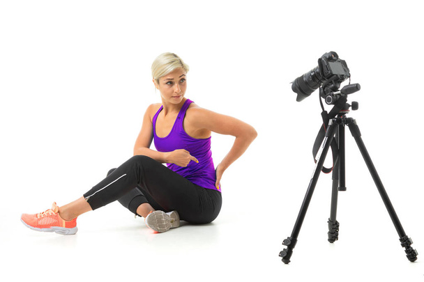 sportswoman video blogger posing against white background  - Foto, imagen
