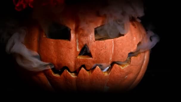 A terrible Halloween pumpkin burns with hellfire. Smoke from the eyes, fire from the mouth. - Footage, Video