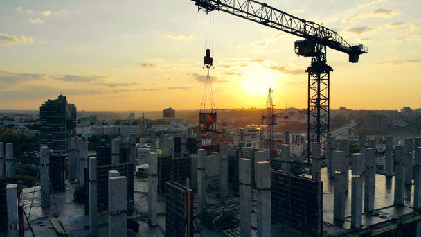 Grue de construction et maison à étages en cours au coucher du soleil
 - Séquence, vidéo