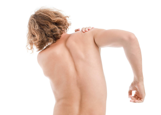 Young man suffering from pain in shoulder on white background - Photo, Image