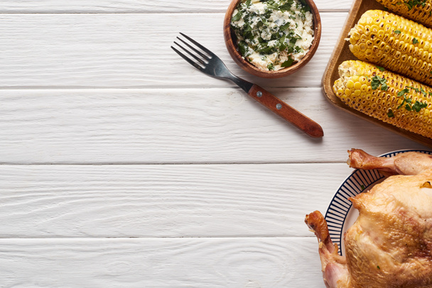 top view of turkey and corn served at white wooden table for Thanksgiving dinner - Fotoğraf, Görsel