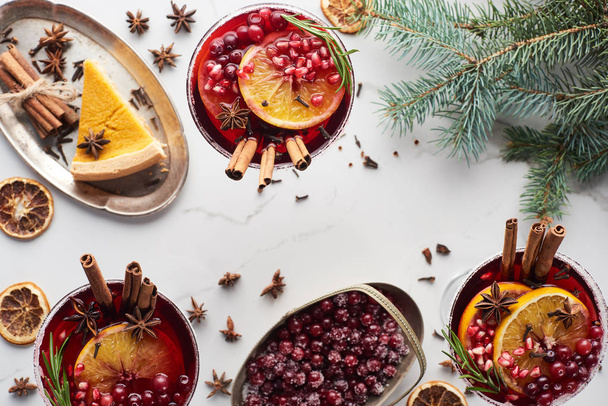 top view of christmas cocktails with orange, pomegranate, cinnamon, pie on tray, frozen cranberry  - Photo, Image