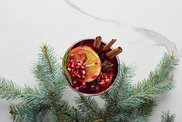 top view of christmas cocktail with orange, pomegranate, cinnamon - Photo, Image