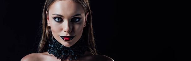 panoramic shot of scary naked vampire girl isolated on black - 写真・画像