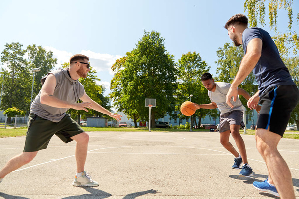 group of male friends playing street basketball - Fotó, kép