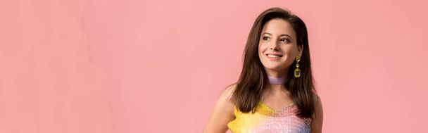 panoramic shot of smiling young stylish disco girl looking away isolated on pink - Foto, afbeelding