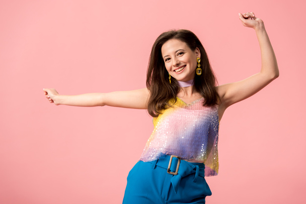 happy young stylish disco girl dancing isolated on pink - Fotó, kép