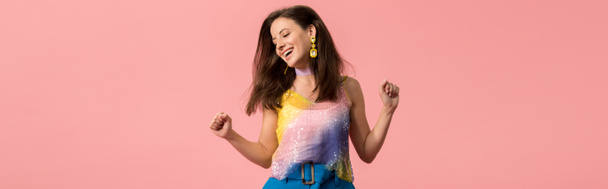 panoramic shot of excited young stylish disco girl dancing isolated on pink - Photo, image