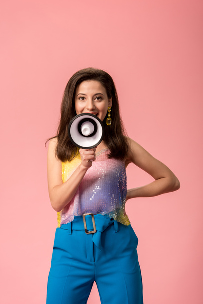 young stylish disco girl with megaphone isolated on pink - 写真・画像