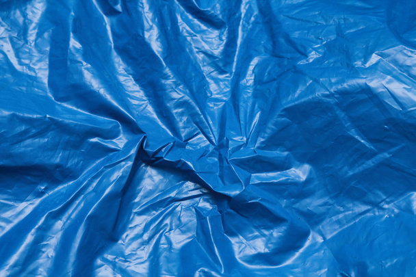 Blue plastic bag texture background. Waste recycling concept. Crumpled polyethylene and cellophane. Reuse materials.  - Fotoğraf, Görsel