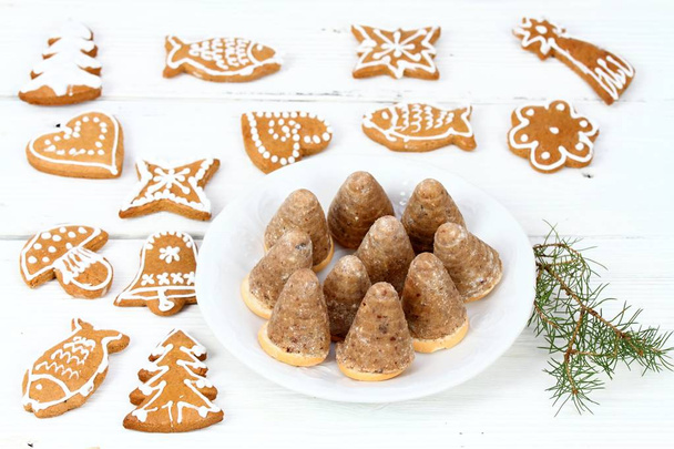 Christmas candies on the white plate.  Xmas homemade sweets named  wasp hives on the plate and gingerbread around - Photo, Image