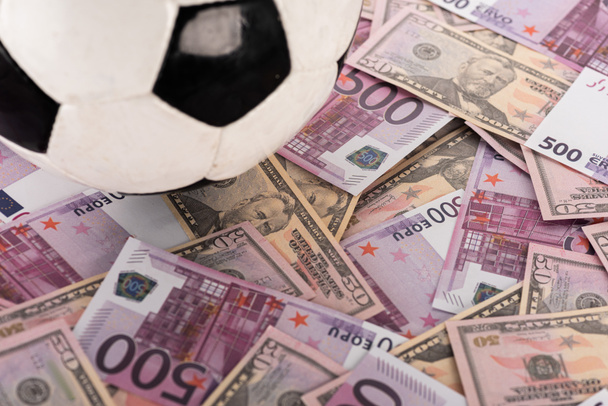 close up view of soccer ball on euro and dollar banknotes, sports betting concept - Photo, Image