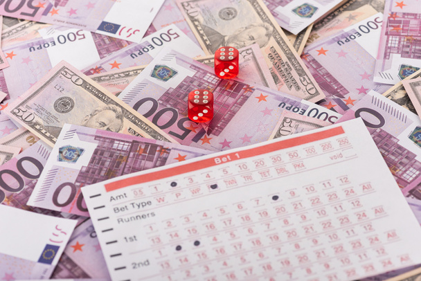 dice and betting list on euro and dollar banknotes, sports betting concept - Photo, Image
