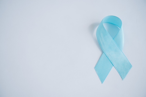 blue awareness ribbon on white background with copy space - Φωτογραφία, εικόνα