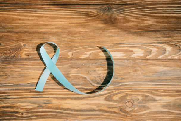 blue awareness ribbon on wooden background with copy space - Photo, Image
