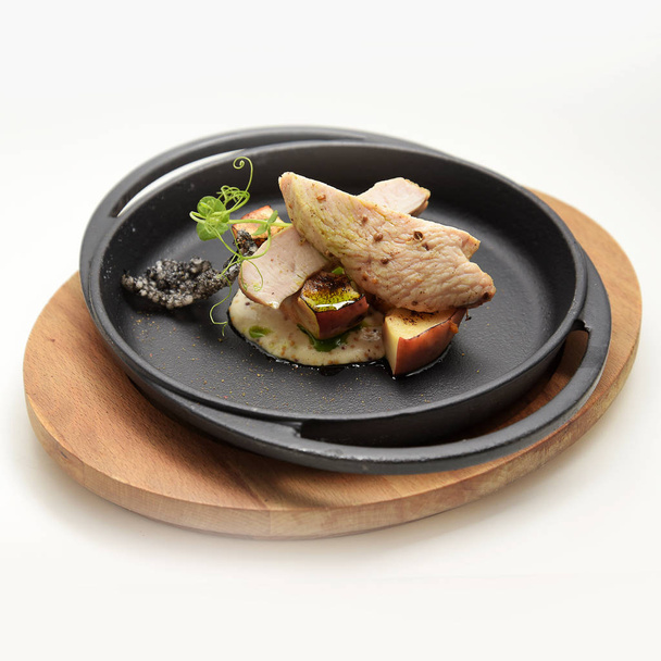 Meat with fruits served on dark plate - Foto, Bild
