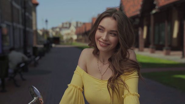 beautiful girl smiling while touching hair  - Filmati, video