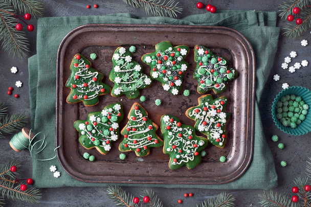 Baking tray with Christmas tree cookies on dark gray textured ba - Φωτογραφία, εικόνα