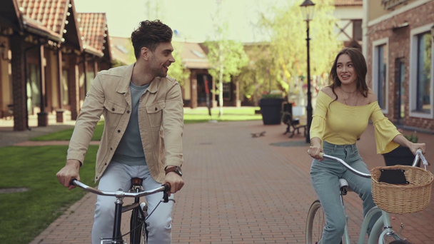 cheerful man and happy woman riding bicycles  - Footage, Video